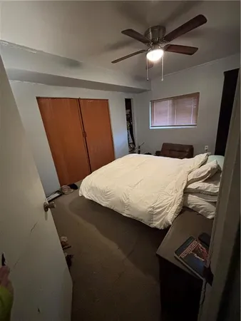 a bedroom with a bed and a mirror