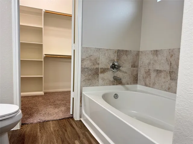 a bathroom with a bathtub and a toilet