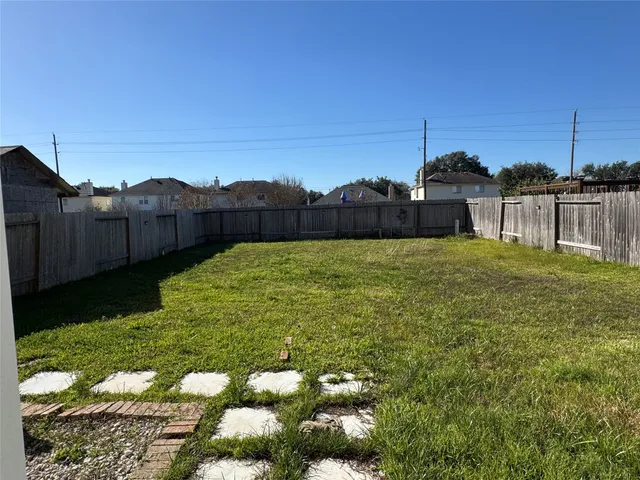 a view of a backyard with plants and lake view