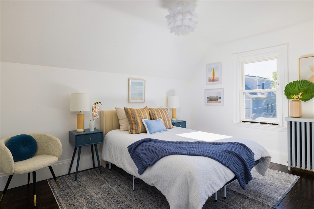 9 Carver Street Somerville, MA 02143 - Photo 6 of 11 a bedroom with a bed and wooden floor