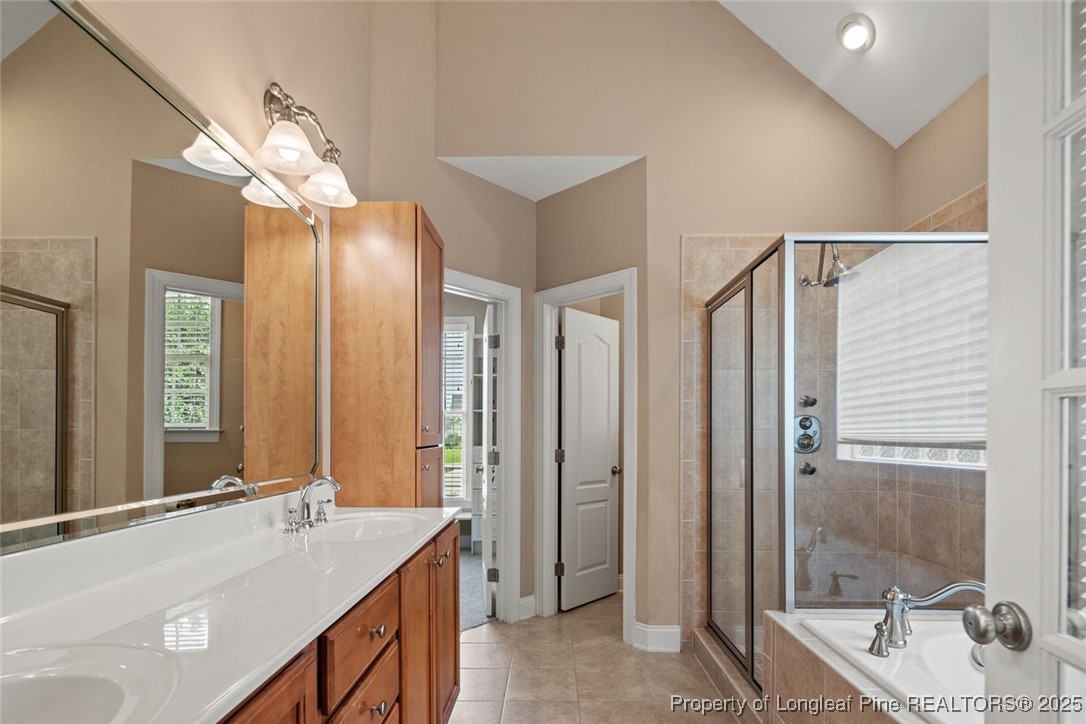 259 Rolling Pines Drive Spring Lake, NC 28390 - Photo 15 of 50 a bathroom with a tub a sink and mirror