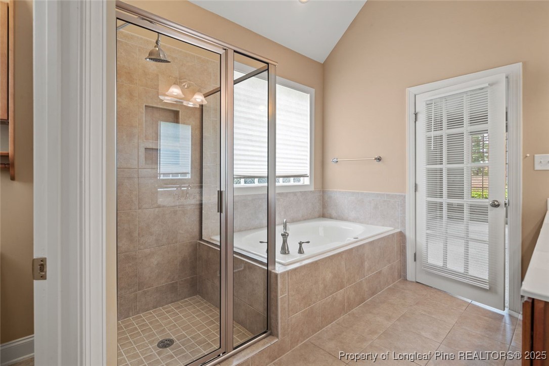 259 Rolling Pines Drive Spring Lake, NC 28390 - Photo 17 of 50 a spacious bathroom with a tub shower and a sink