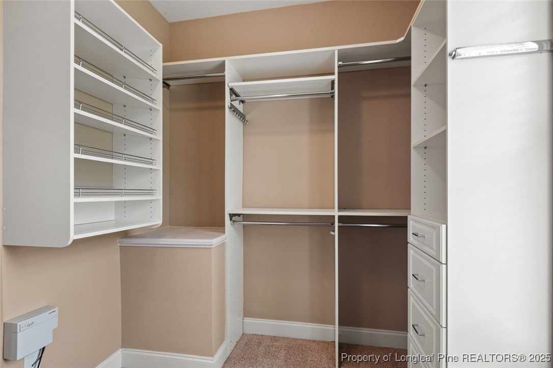259 Rolling Pines Drive Spring Lake, NC 28390 - Photo 19 of 50 a view of walk in closet with empty racks