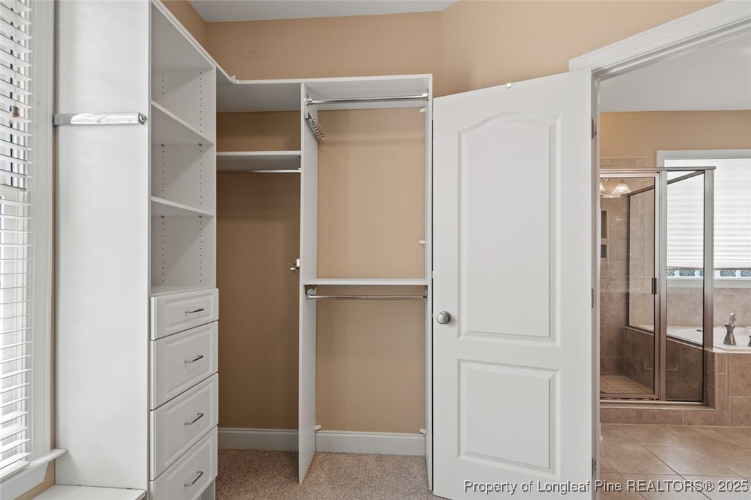 259 Rolling Pines Drive Spring Lake, NC 28390 - Photo 20 of 50 a view of walk in closet with empty racks
