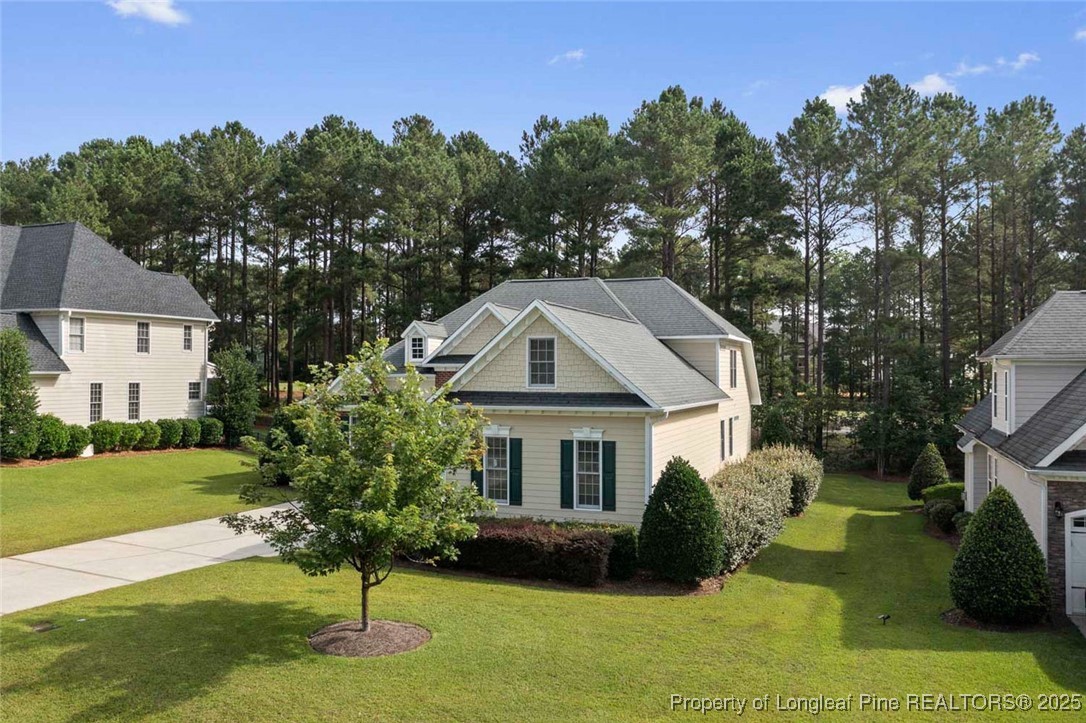 259 Rolling Pines Drive Spring Lake, NC 28390 - Photo 2 of 50 a front view of a house with a yard garage and outdoor seating