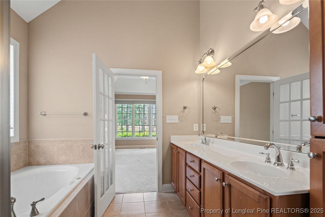 259 Rolling Pines Drive Spring Lake, NC 28390 - Photo 21 of 50 a bathroom with a sink double vanity granite tub and a mirror