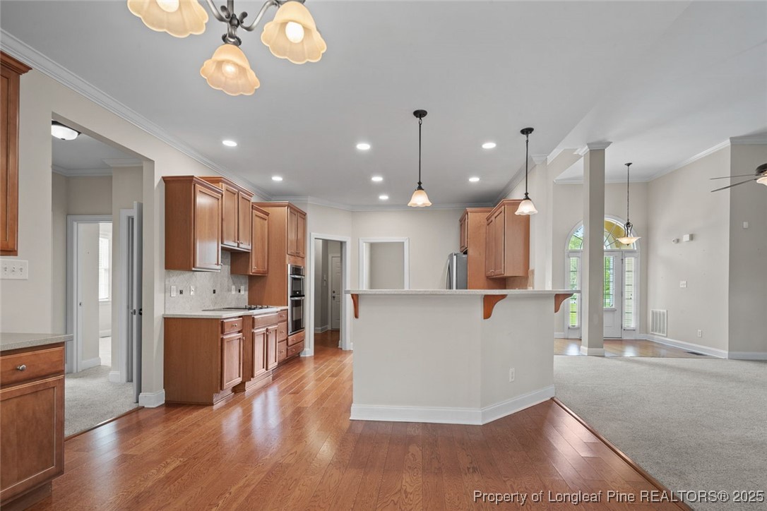 259 Rolling Pines Drive Spring Lake, NC 28390 - Photo 27 of 50 a living room with stainless steel appliances kitchen island a dining table and chairs