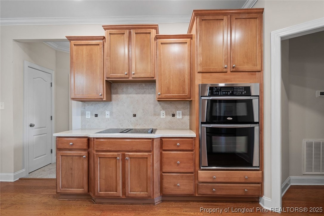 259 Rolling Pines Drive Spring Lake, NC 28390 - Photo 29 of 50 a kitchen with stainless steel appliances wooden cabinets and stove
