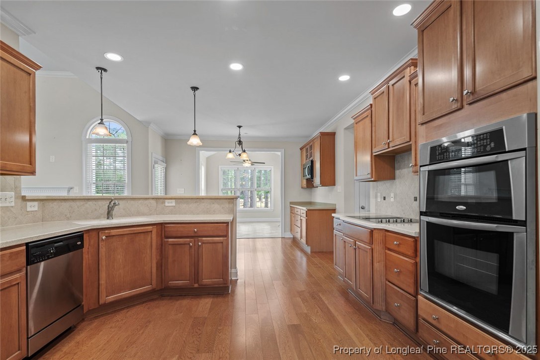 259 Rolling Pines Drive Spring Lake, NC 28390 - Photo 31 of 50 a kitchen with stainless steel appliances granite countertop wooden cabinets stove a sink and dishwasher