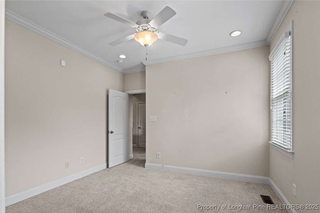 259 Rolling Pines Drive Spring Lake, NC 28390 - Photo 38 of 50 an empty room with a ceiling fan and a window