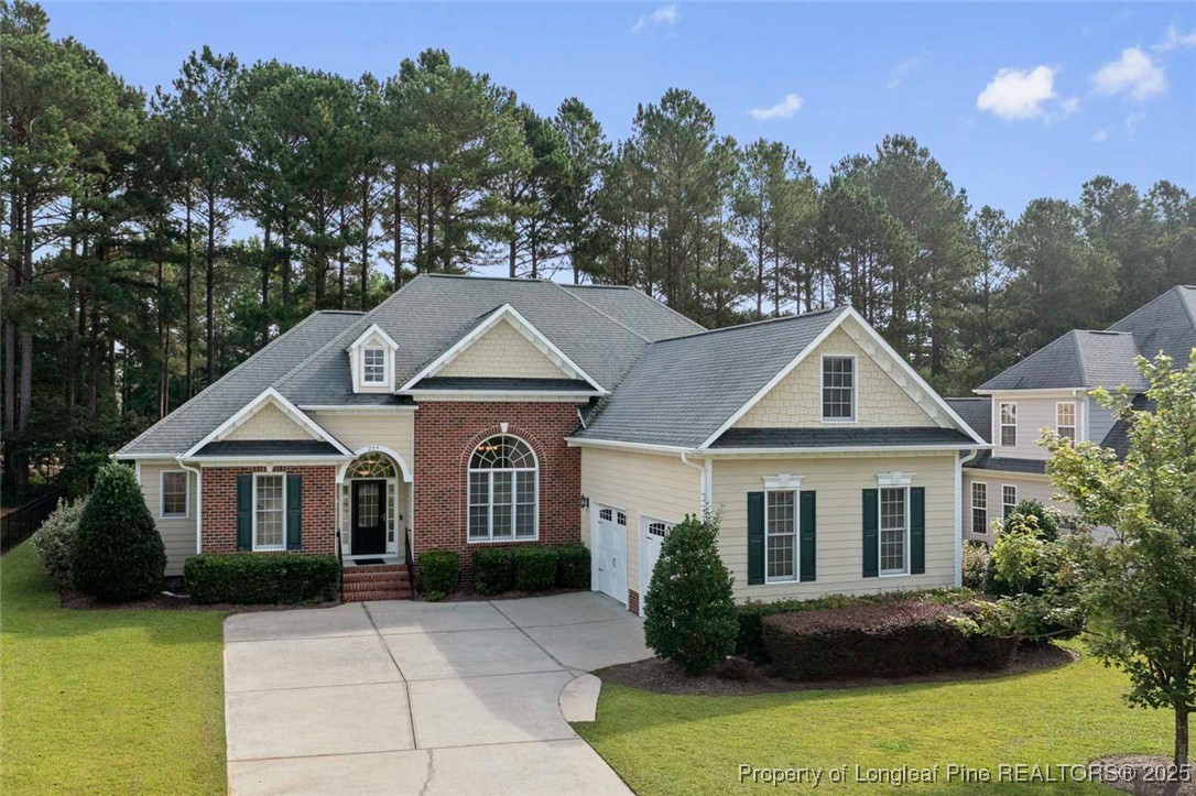 259 Rolling Pines Drive Spring Lake, NC 28390 - Photo 4 of 50 a front view of a house with garden