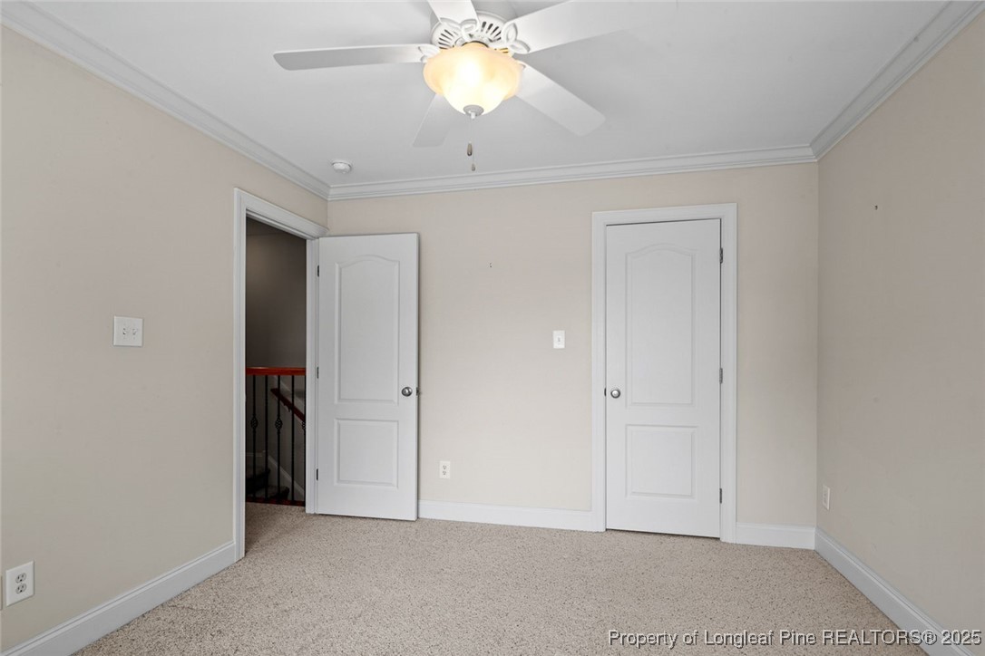 259 Rolling Pines Drive Spring Lake, NC 28390 - Photo 45 of 50 an empty room with closet and a chandelier fan