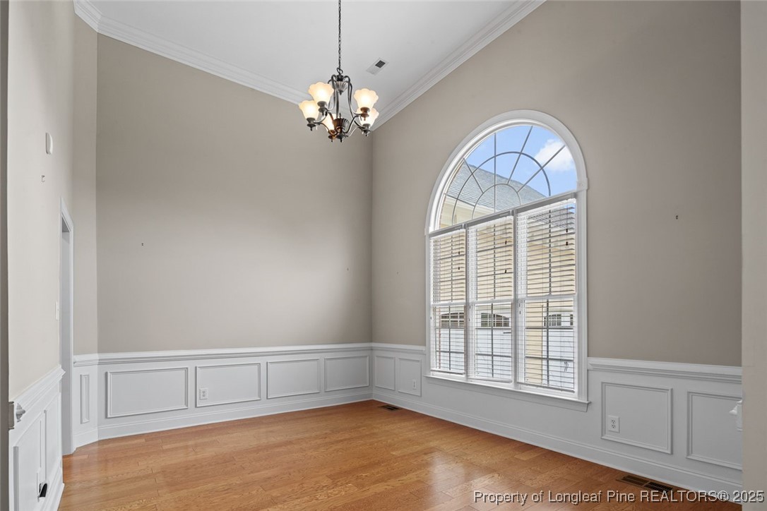 259 Rolling Pines Drive Spring Lake, NC 28390 - Photo 9 of 50 wooden floor in an empty room with a window