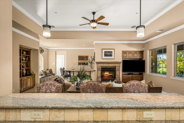 a living room with furniture a large window and a fireplace