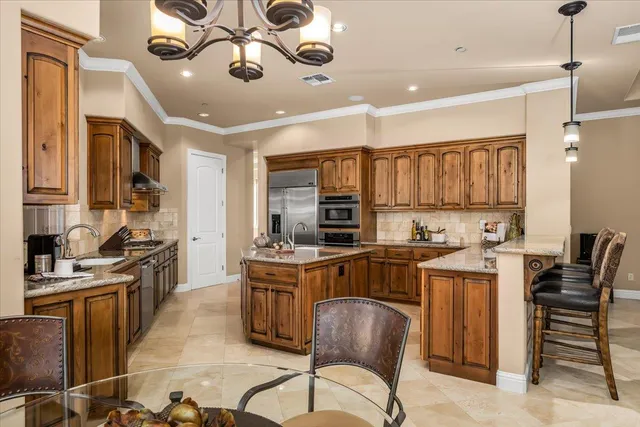 a dining room with furniture a chandelier and wooden floor