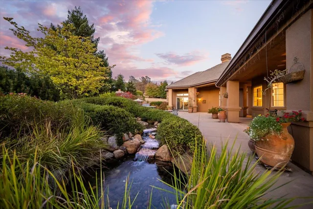 a view of a patio with table and chairs and potted plants