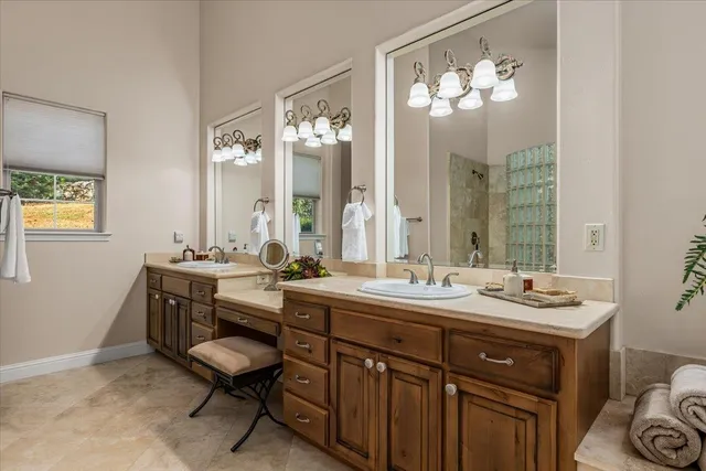 a spacious bathroom with a granite countertop tub and a large window