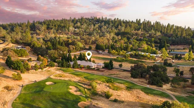 a view of a patio with chairs and potted plants