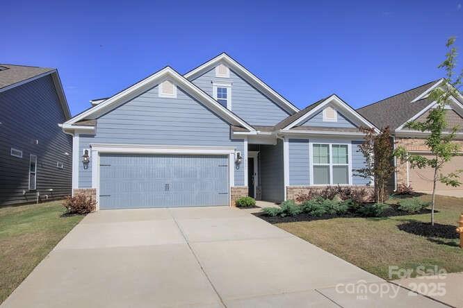 4245 Millstream Road Denver, NC 28037 - Photo 1 of 47 a front view of a house with a yard and garage