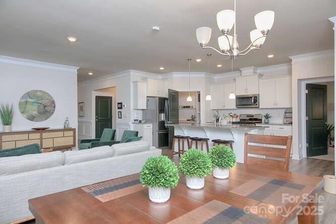 4245 Millstream Road Denver, NC 28037 - Photo 11 of 47 a kitchen with stainless steel appliances granite countertop a refrigerator a stove a sink and a dining table with garden view
