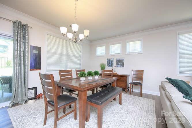 4245 Millstream Road Denver, NC 28037 - Photo 13 of 47 a view of a dining room with furniture window and wooden floor