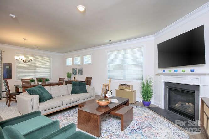 4245 Millstream Road Denver, NC 28037 - Photo 14 of 47 a living room with furniture a flat screen tv and a fireplace