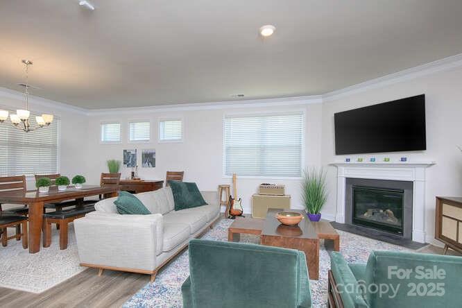 4245 Millstream Road Denver, NC 28037 - Photo 15 of 47 a living room with fireplace a fireplace and a flat screen tv