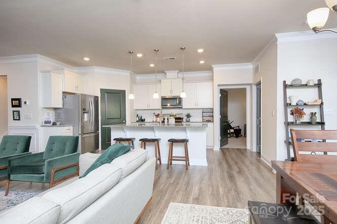 4245 Millstream Road Denver, NC 28037 - Photo 18 of 47 a living room with stainless steel appliances kitchen island granite countertop furniture and a kitchen view