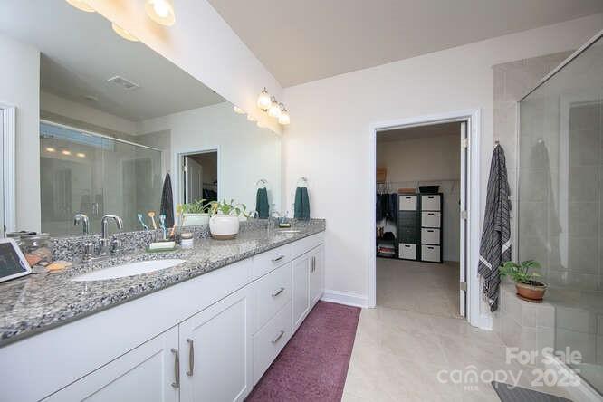 4245 Millstream Road Denver, NC 28037 - Photo 25 of 47 a bathroom with a granite countertop sink and a mirror