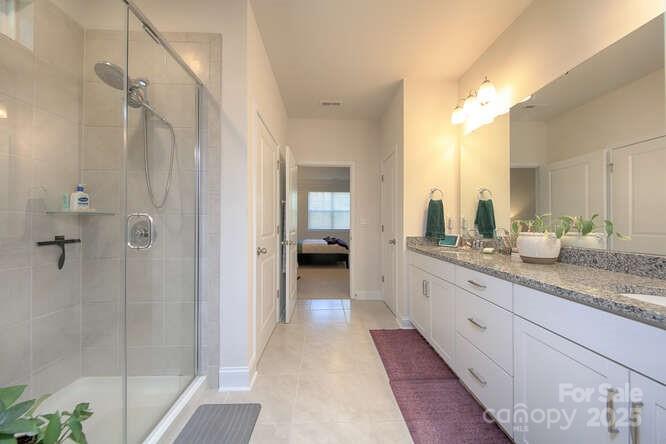 4245 Millstream Road Denver, NC 28037 - Photo 26 of 47 a bathroom with a double vanity sink and a mirror