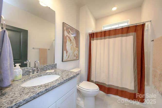 4245 Millstream Road Denver, NC 28037 - Photo 34 of 47 a bathroom with a granite countertop sink a toilet and shower