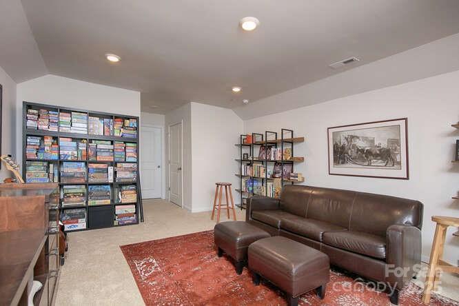 4245 Millstream Road Denver, NC 28037 - Photo 38 of 47 a living room with furniture and a book shelf