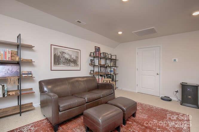 4245 Millstream Road Denver, NC 28037 - Photo 39 of 47 a living room with furniture and a wooden floor