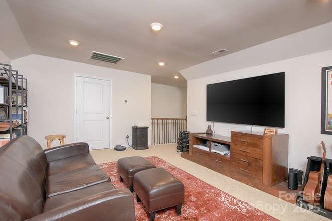 4245 Millstream Road Denver, NC 28037 - Photo 40 of 47 a living room with furniture and a flat screen tv