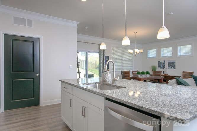 4245 Millstream Road Denver, NC 28037 - Photo 4 of 47 a large kitchen with granite countertop a sink and a wooden floor