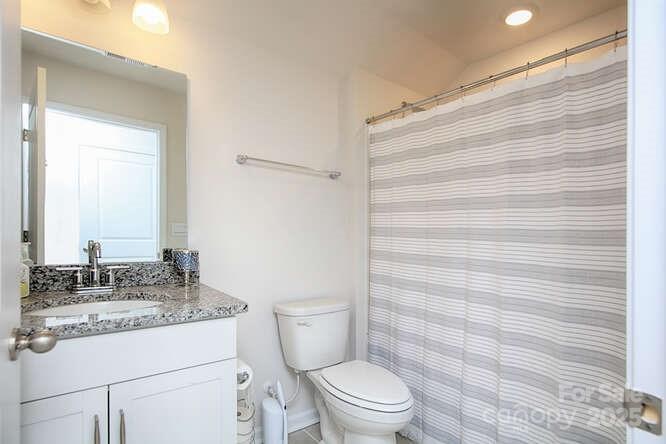 4245 Millstream Road Denver, NC 28037 - Photo 41 of 47 a bathroom with a granite countertop toilet sink and mirror