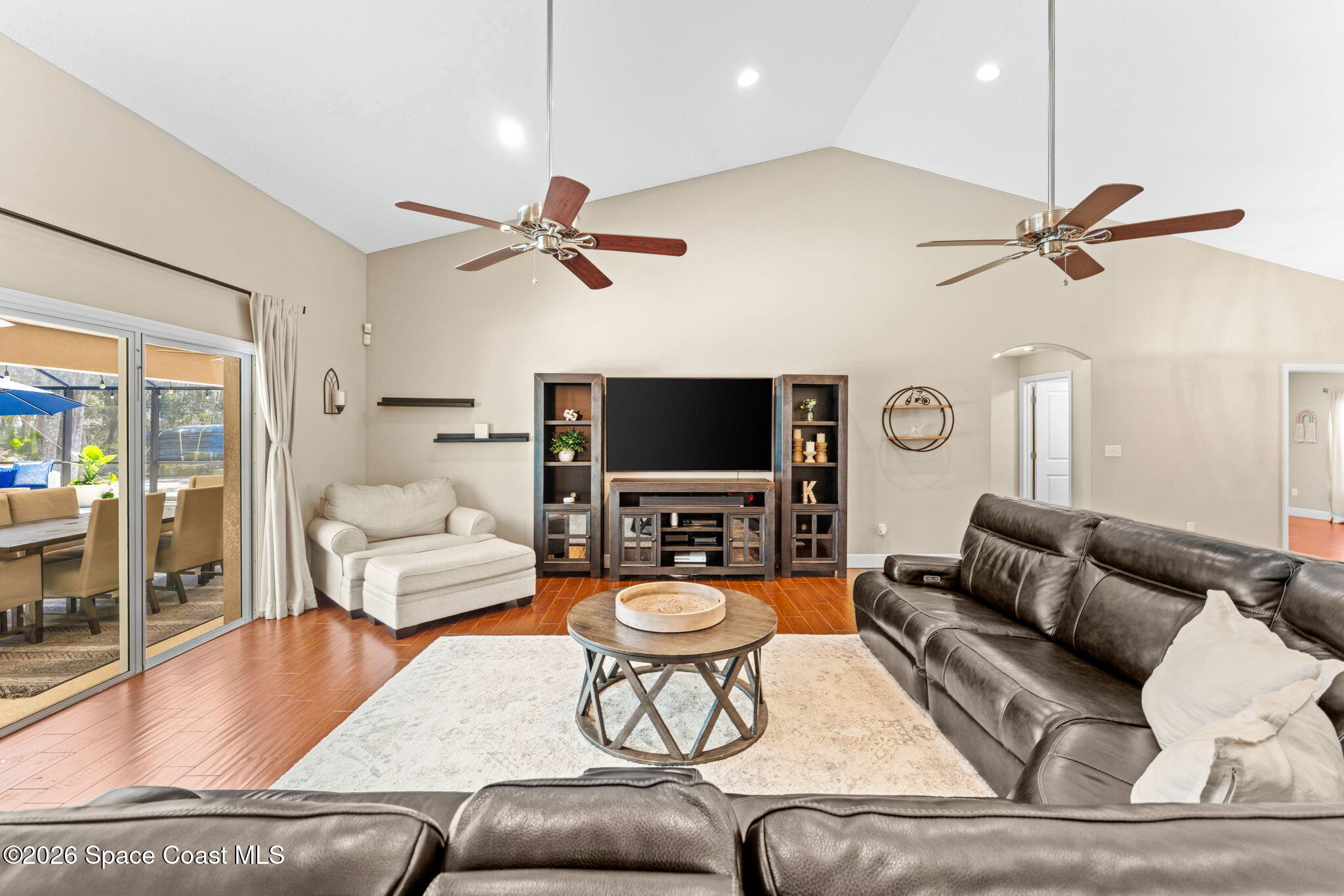 1695 Arch Road Mims, FL 32754 - Photo 15 of 57 a living room with furniture a ceiling fan and a flat screen tv