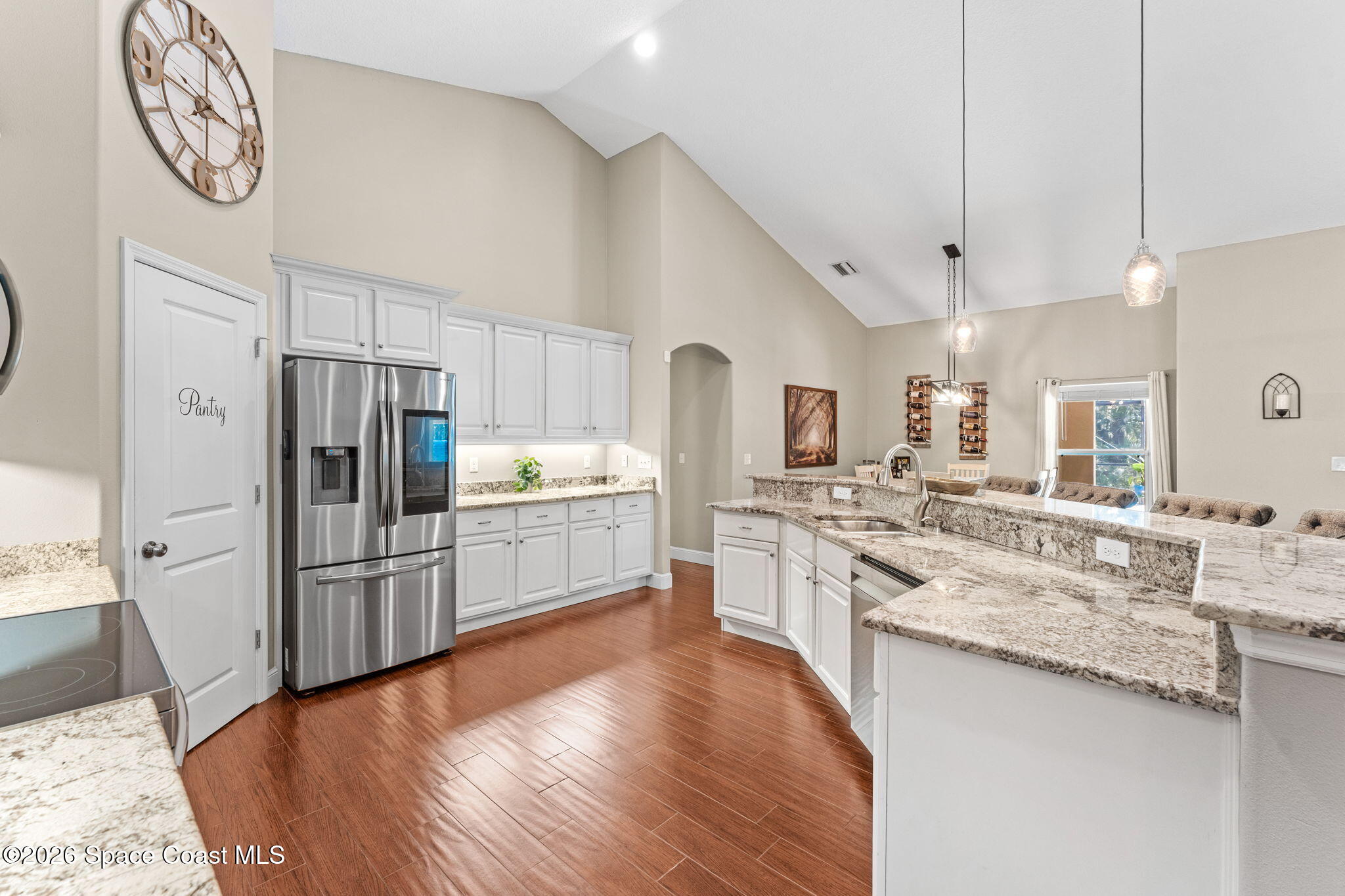 1695 Arch Road Mims, FL 32754 - Photo 18 of 57 a large kitchen with cabinets wooden floor and stainless steel appliances