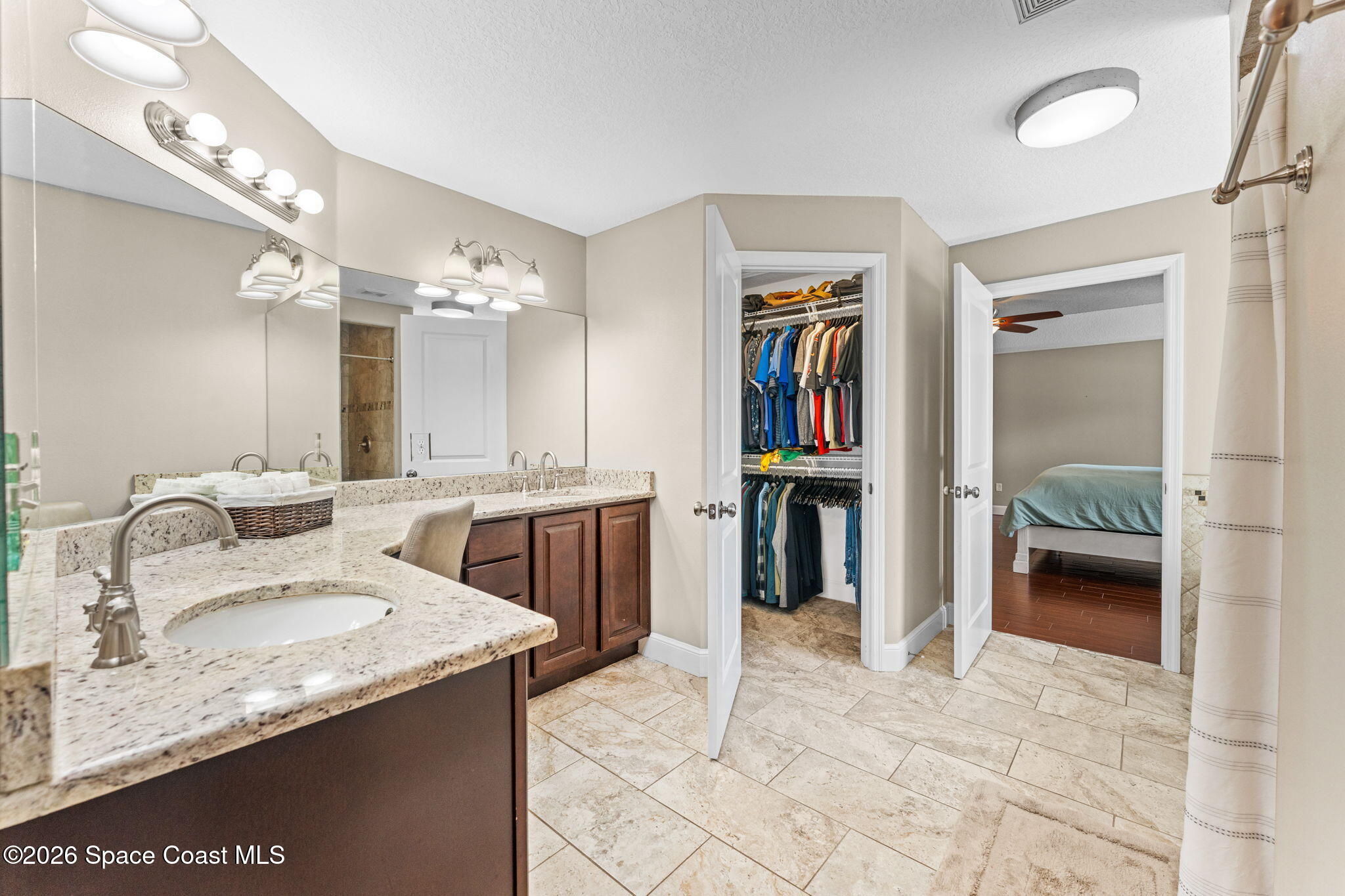 1695 Arch Road Mims, FL 32754 - Photo 27 of 57 a en suite bathroom with a granite countertop sink and a mirror