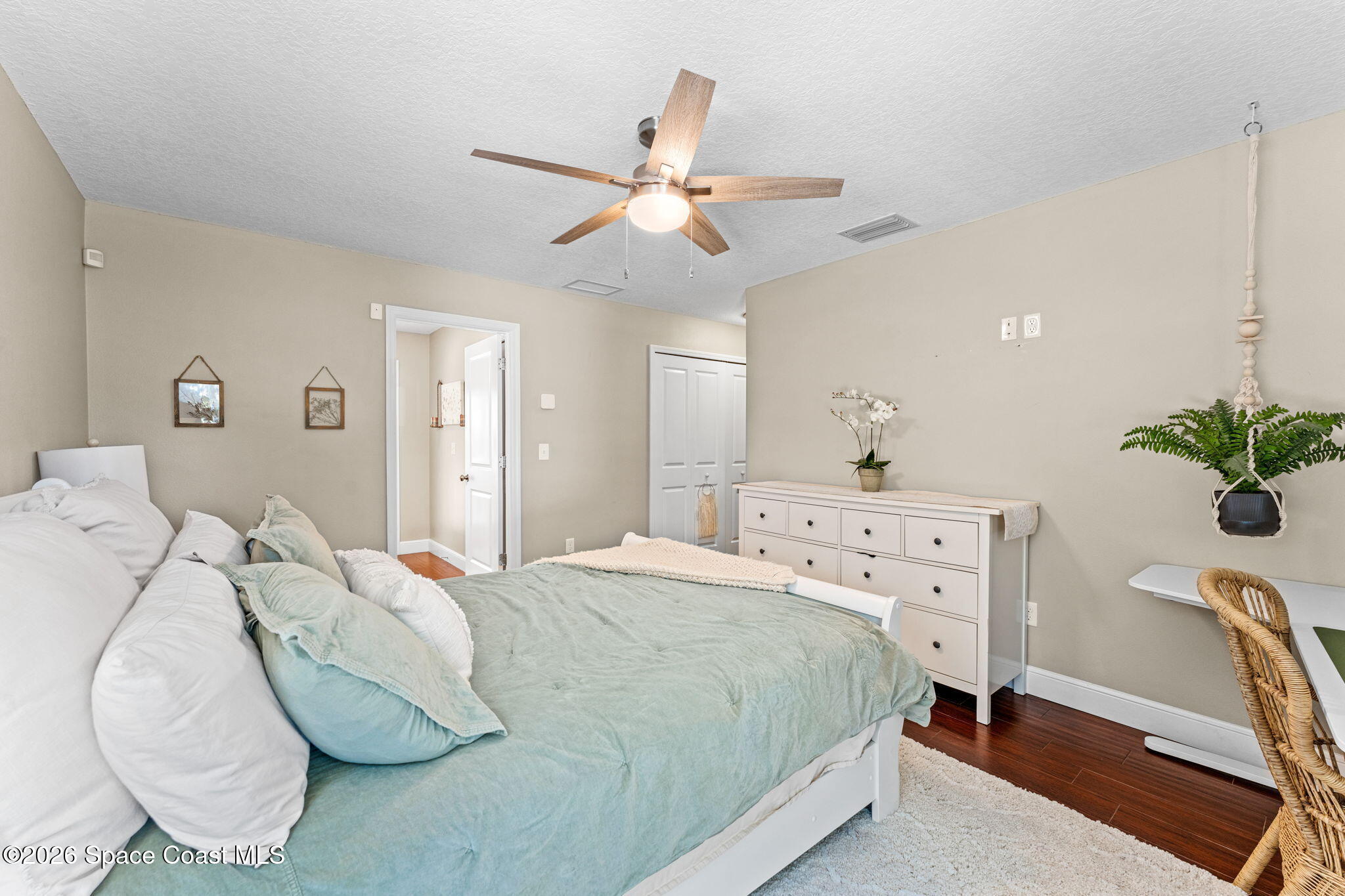 1695 Arch Road Mims, FL 32754 - Photo 29 of 57 a bedroom with a bed and a chandelier