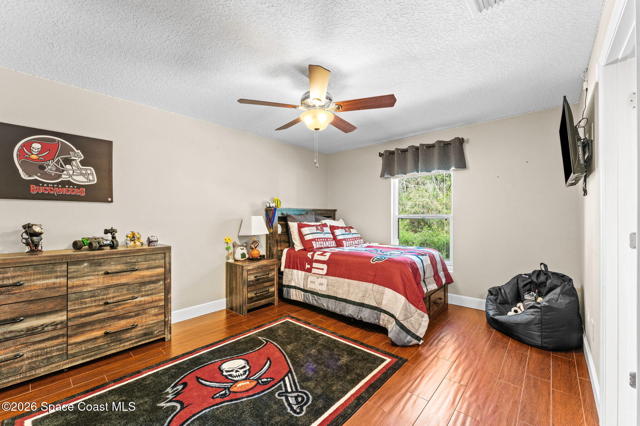 1695 Arch Road Mims, FL 32754 - Photo 35 of 57 a bedroom with a bed and a chandelier