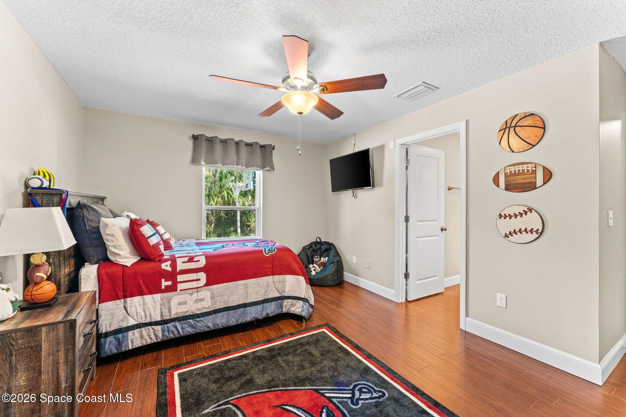 1695 Arch Road Mims, FL 32754 - Photo 36 of 57 a bedroom with a bed and wooden floor