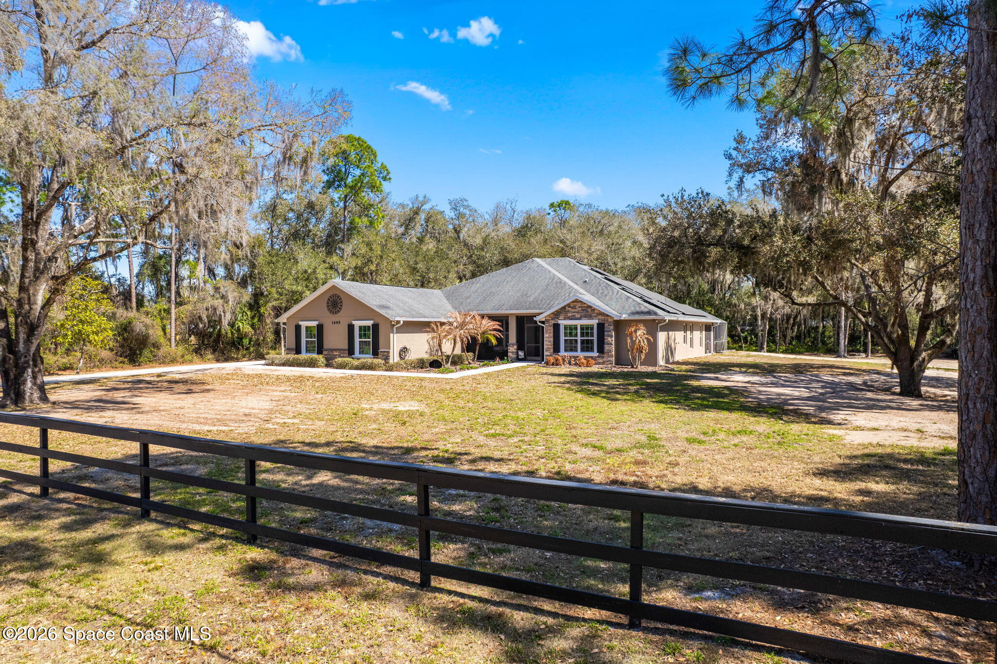 1695 Arch Road Mims, FL 32754 - Photo 4 of 57 a front view of a house with a yard