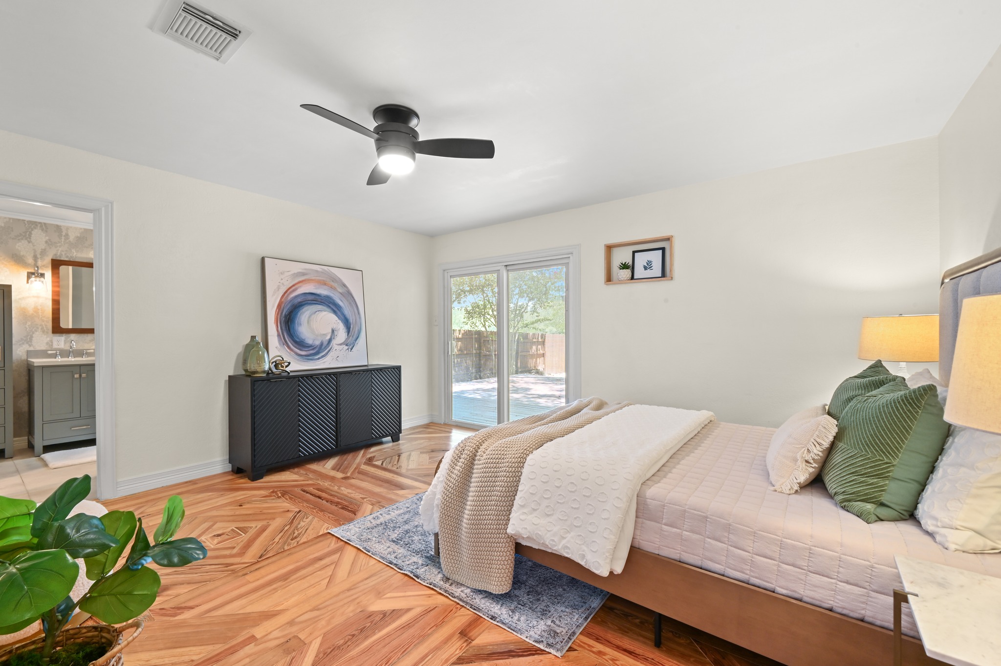708 Shade Tree Drive Austin, TX 78748 - Photo 4 of 32 Featuring 3 bedrooms including this secluded main floor primary suite with an updated ensuite bathroom and walkout access to the back deck.