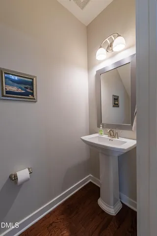 a bathroom with a sink mirror and vanity