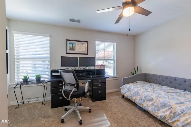 a bedroom with a bed and a desk