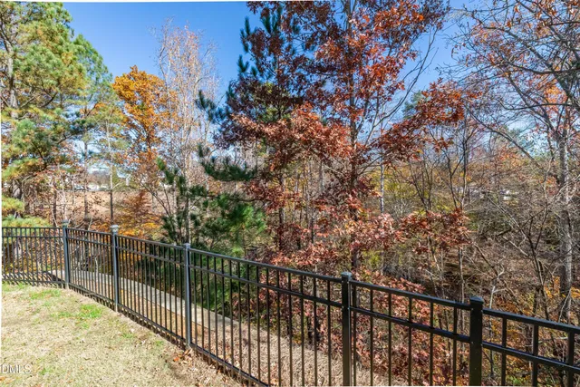 a front view of a house with swimming pool and fire pit