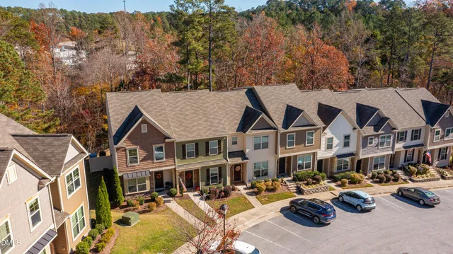 an aerial view of a house with swimming pool and patio