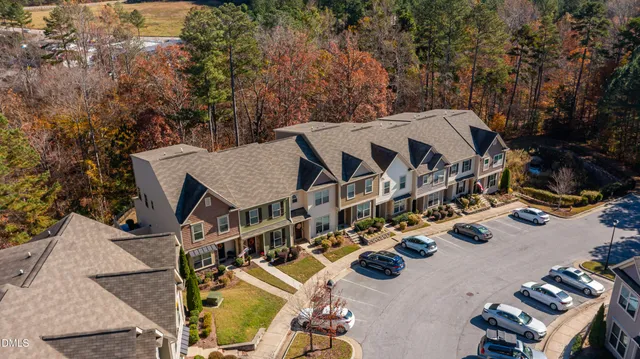 an aerial view of a house with swimming pool and patio