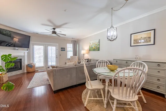 a view of a dining room with furniture a chandelier and wooden floor